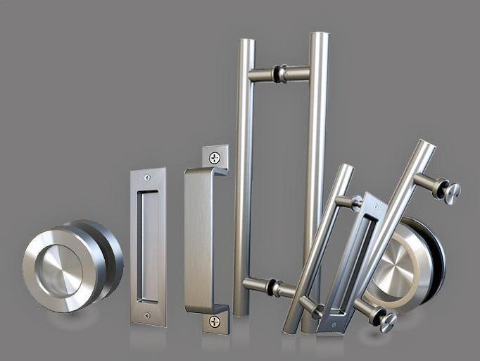 Assorted metallic door handles and knobs from our product archive elegantly displayed on a gray background.