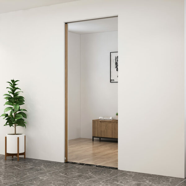 Un interno moderno caratterizzato da una porta scorrevole a scomparsa che conduce a una stanza ben illuminata con una consolle in legno, opere d'arte incorniciate e una pianta in vaso accanto all'ingresso.