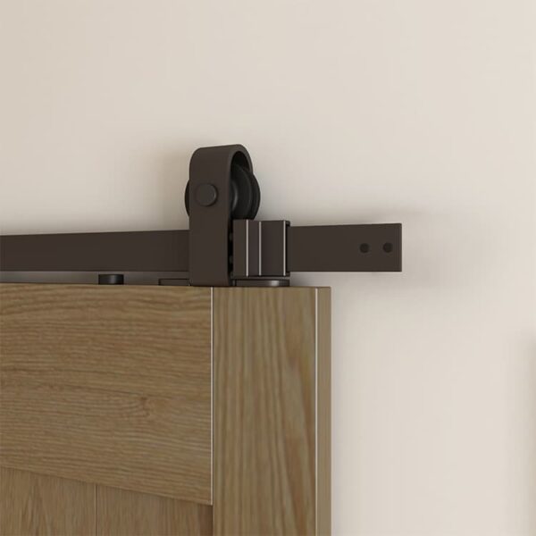 Close-up of a sliding wooden door with modern Top Mount Sliding Door Hardware on a beige wall.