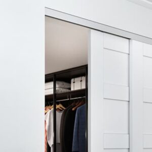 A tidy closet features efficient design with sliding white doors, revealing a clothes rack and boxes on the top shelf.