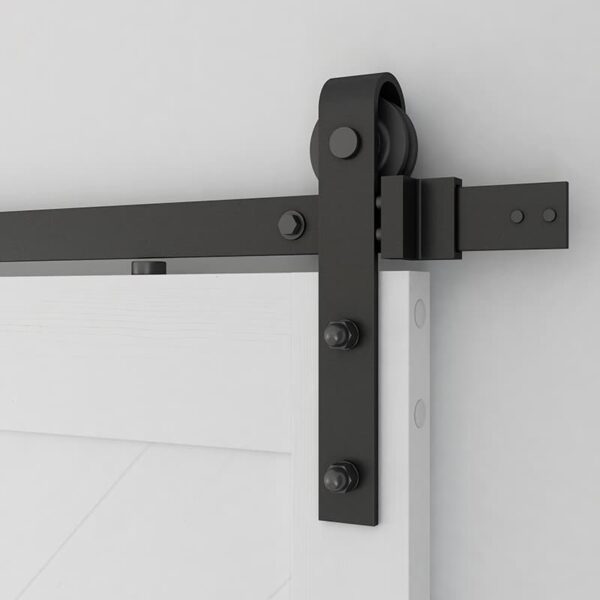 Close-up of a black sliding barn door hardware mechanism mounted on a 36in x 84in White Chevron Barn Door, 5 Lites, DIY Assembly, Knocked Down Version and wall.