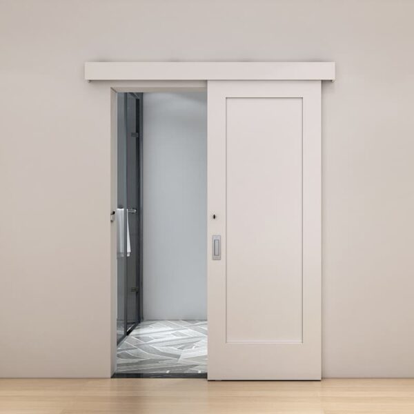 A modern elevator features a top-mounted bathroom entry with a soft-closing wood door, stainless steel inside, and marble floor in a beige-walled hallway.