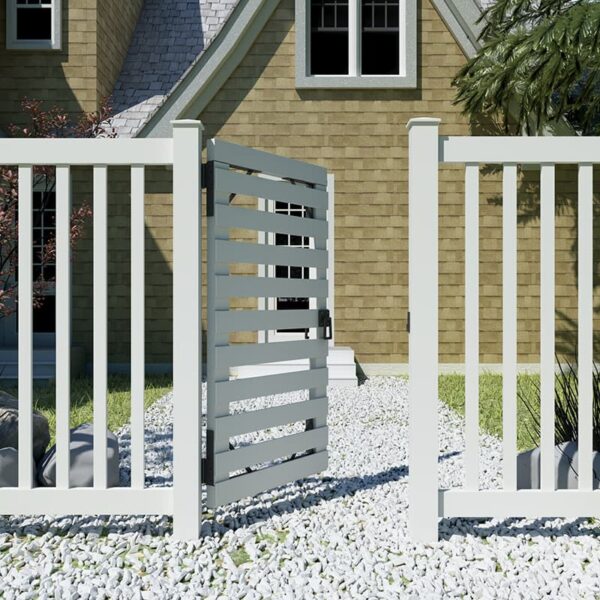 A white slatted gate with a lockable latch is partially open within a picket fence, surrounded by gravel, with a beige house in the background.