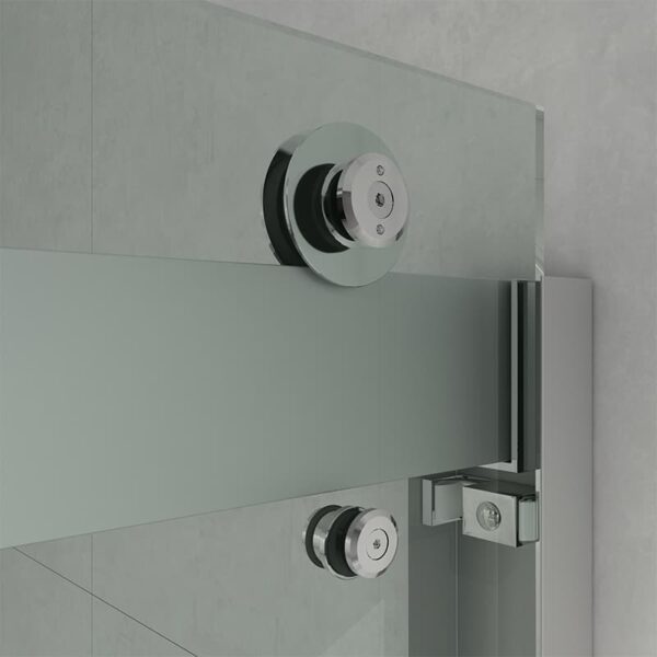 Close-up of a Tempered Glass Shower Door, Frameless, Modern Bypass Sliding Style with stainless steel hinges and handles on a gray wall background.