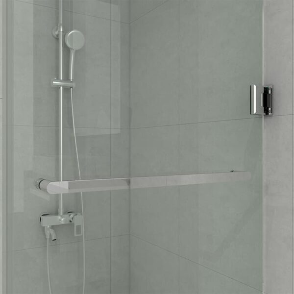 Modern corner shower with a mounted handheld showerhead, a glass hinged shower door, and light gray tiles.