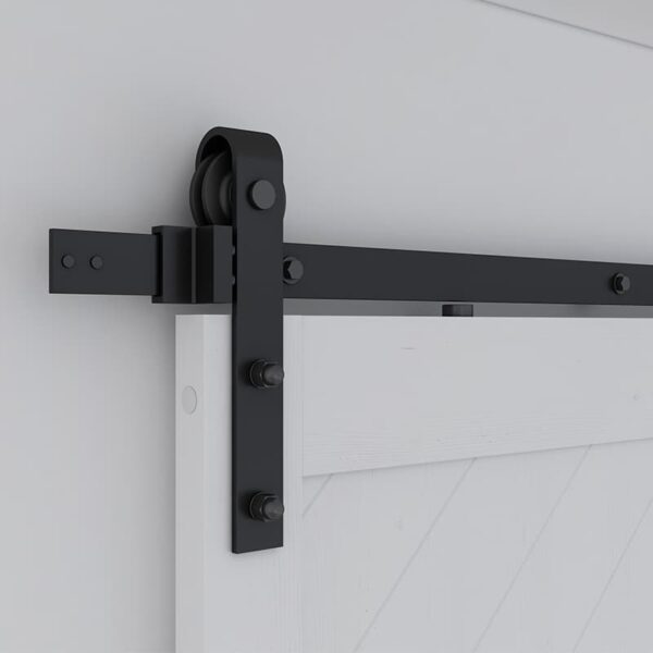 An 36 x 84 inch black sliding barn door hardware system mounted on a white wall.