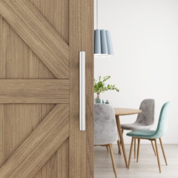 A sliding door with a stainless steel barn handle is ajar, revealing a dining area with a round table, four chairs, and a plant.