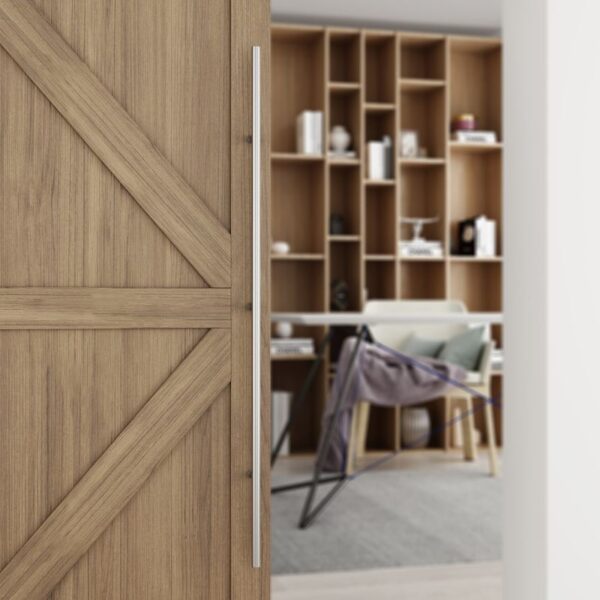 A partially open barn door reveals a modern office. It has a 60-inch stainless steel push-pull handle.