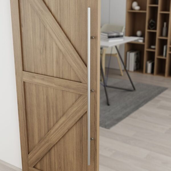 The 60-inch wooden sliding barn door, with a stainless steel handle, is partly open to reveal a modern office with desk and shelves.