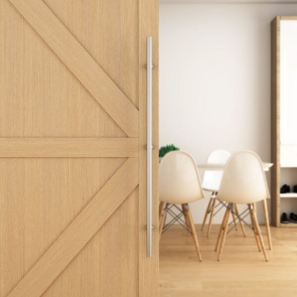 A sliding wooden door with a stainless steel handle reveals a room with a table and four white chairs.