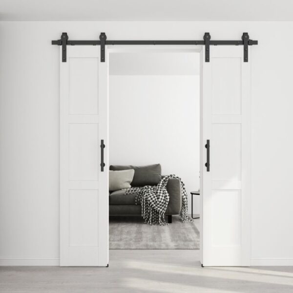 The Knocked Down Sliding Barn Door, easy to assemble and space-saving, opens to a living room with a gray sofa and matching decor.