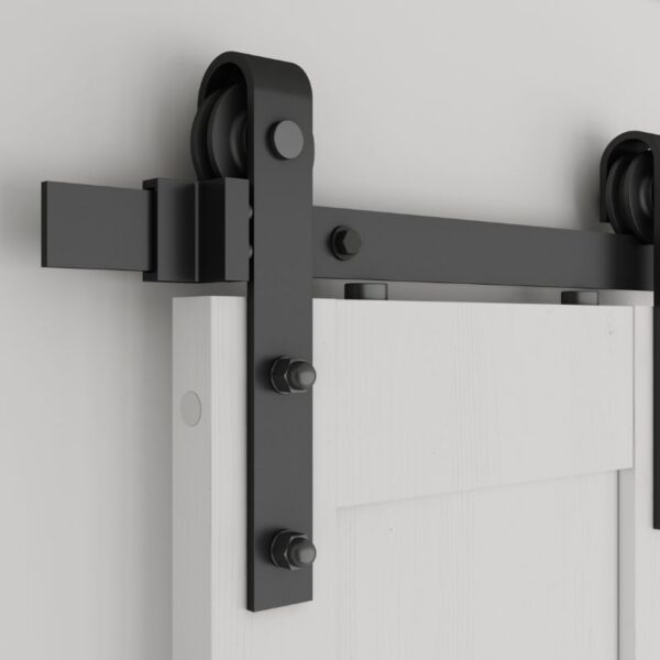 Close-up of space-saving black metal sliding barn door hardware from Knocked Down Sliding Barn Door, mounted on a white interior door.