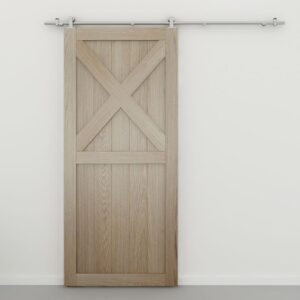 A light wood barn door with an X design on a metal rail is mounted on a white wall.