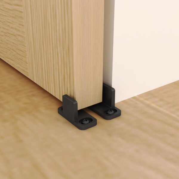 Durable floor guide for heavy sliding doors: adjustable, black plastic base, installs seamlessly on wooden floors.