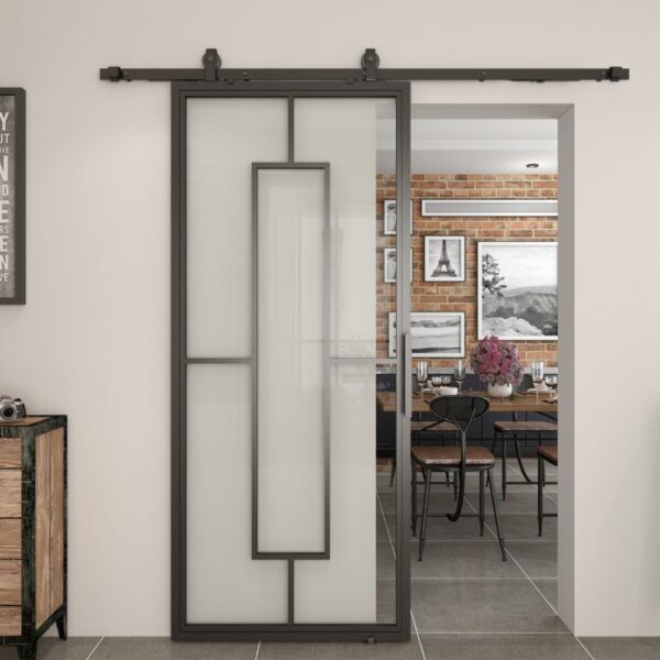 The modern dining room, with brick walls and framed art, features a steel-framed sliding barn door of frosted tempered glass.