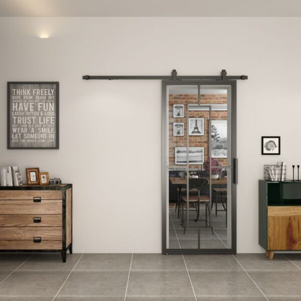 A room with a steel-framed sliding glass barn door, frosted glass, wall art, a wooden dresser, and a sideboard leads to a dining area.