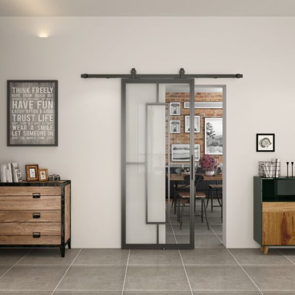 A black-framed sliding glass barn door contrasts a wooden dresser and green cabinet, blending rustic charm with modern elegance.