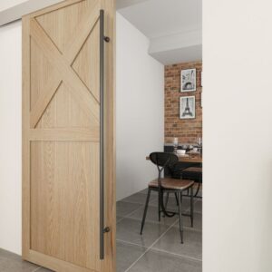 The dining area features a wooden sliding door with a black stainless steel handle. Inside, brick walls, framed photos, and dark chairs on gray tiles create an inviting atmosphere.