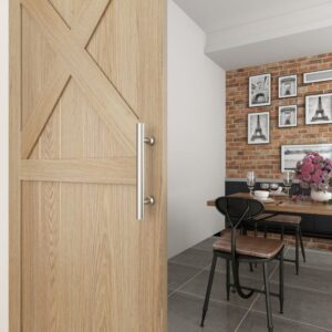 A customizable Stainless Steel Door Pull enhances a wooden sliding door showcasing a dining area with a brick wall and floral centerpiece.