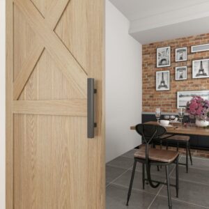 A sleek black sliding door leads to a dining area with a table, chairs, Eiffel Tower art, and pink flowers in a vase.