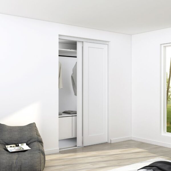 The sturdy steel and MDF closet door brightens the room. A shirt and jacket hang inside. Nearby, a chair sits by the window, with a magazine on the floor.