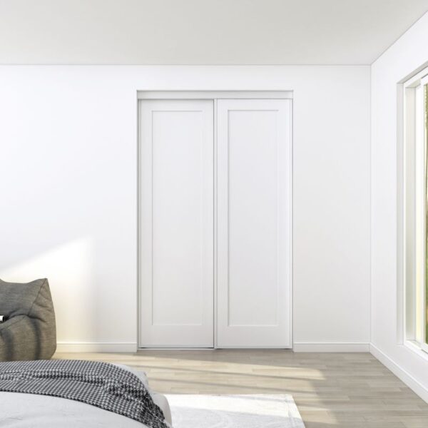 A bedroom with a gray chair, partially visible bed, and closed white sliding closet doors made from sturdy steel and MDF.