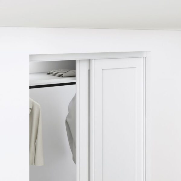 A partially open white closet door reveals a beige jacket and folded towel. Made of steel and MDF, the door adds elegance to the room.