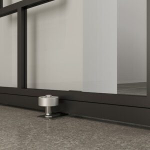 The Brushed Stainless Steel Barn Door Guide ensures smooth, secure sliding across the polished concrete floor.