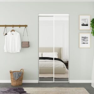 A bedroom features a 48" Steel Frame Mirror Closet Door reflecting the bed, a coat rack with shirt and bag, and a charming woven basket.