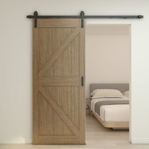 O ușă de hambar din stejar parțial deschisă, cu feronerie neagră, dezvăluie un dormitor minimalist, cu un pat îngrijit și un decor neutru.
