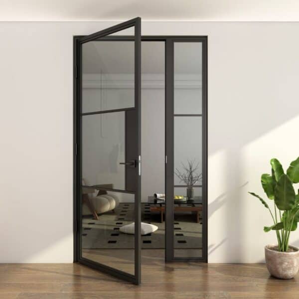 Sleek black-framed steel and glass door opens to a minimalist living room with low table, decor, and greenery.