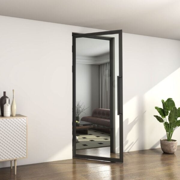Open matte black steel swing door reveals modern living room with brown sofa, coffee table, rug, and green plant.