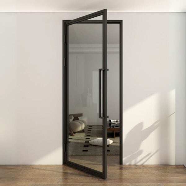 Partially open black steel glass swing door connects wood-floored hallway to a modern minimalist living room.