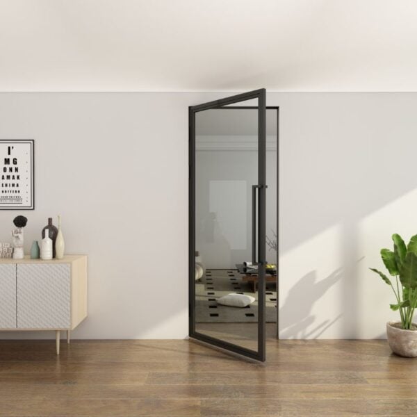 A matte black glass steel swing door, partially open in a modern room with wooden floors, sideboard, decor, and a potted plant.