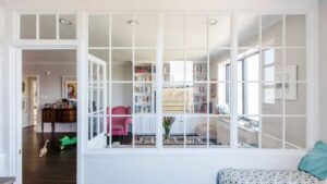 Elegant glass partition for home office or living space, providing openness and light while maintaining separation; ideal for modern, stylish interiors.