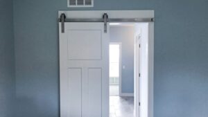 Ceiling-mounted barn door room divider with sliding mechanism, ideal for creating flexible space separation in modern interiors. Perfect for enhancing room functionality and style.