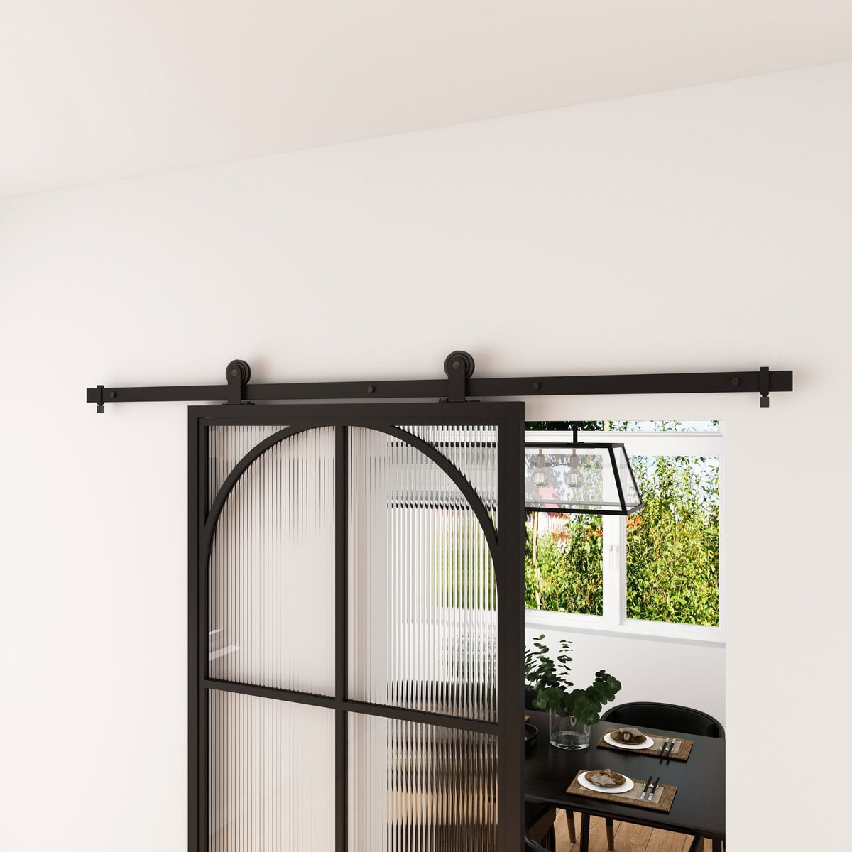 Black Versaille barn door with glass panels, sliding on a black metal track, installed in a modern interior with a dining area visible through the door.