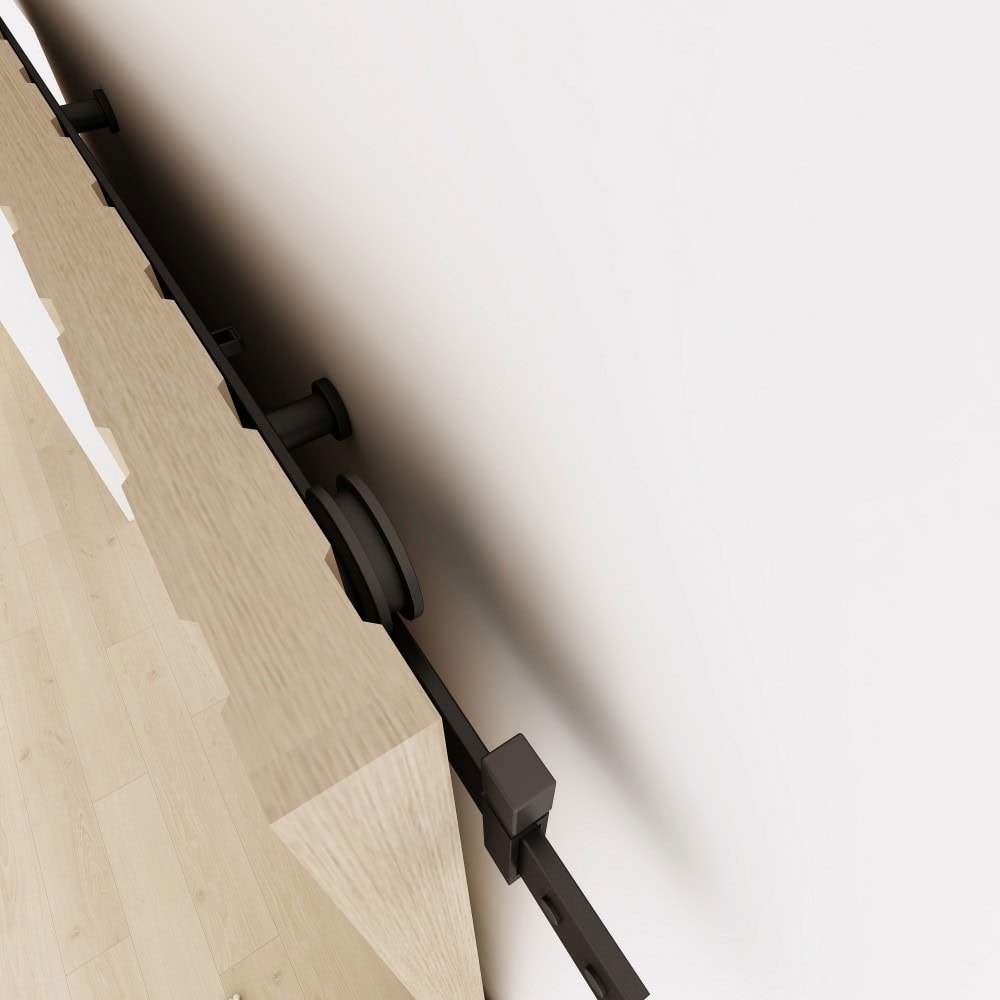 Close-up of black concealed roller sliding barn door hardware system mounted on a wall, showcasing the sleek design and smooth operation.