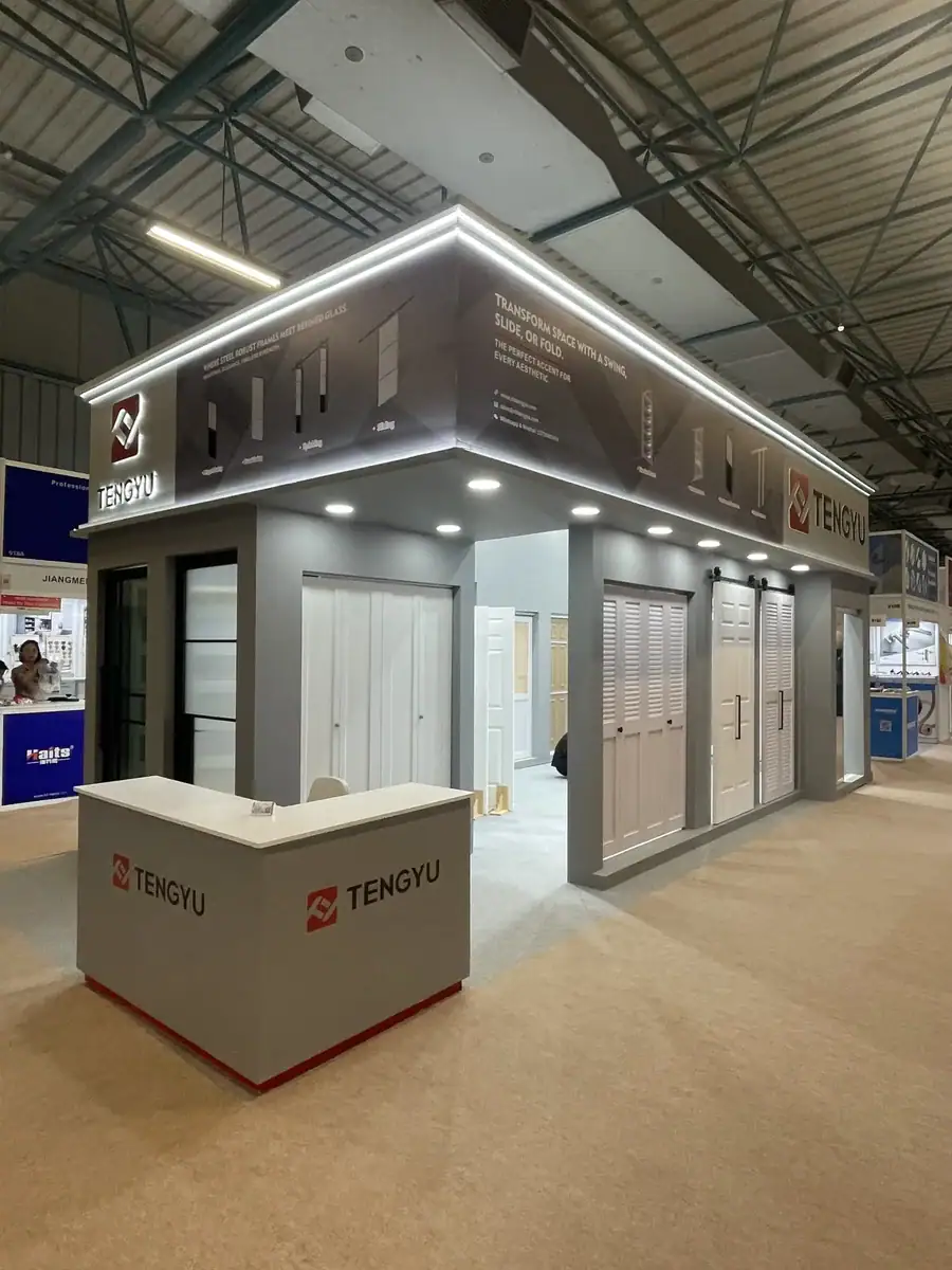 Tengyu exhibition booth showcasing doors and windows at a trade show, with modern design and branding, highlighting their product range and company logo.
