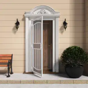 White surface mount steel security door with decorative arch and expanded metal screen, installed on a beige house exterior with black wall-mounted lanterns and a potted shrub.
