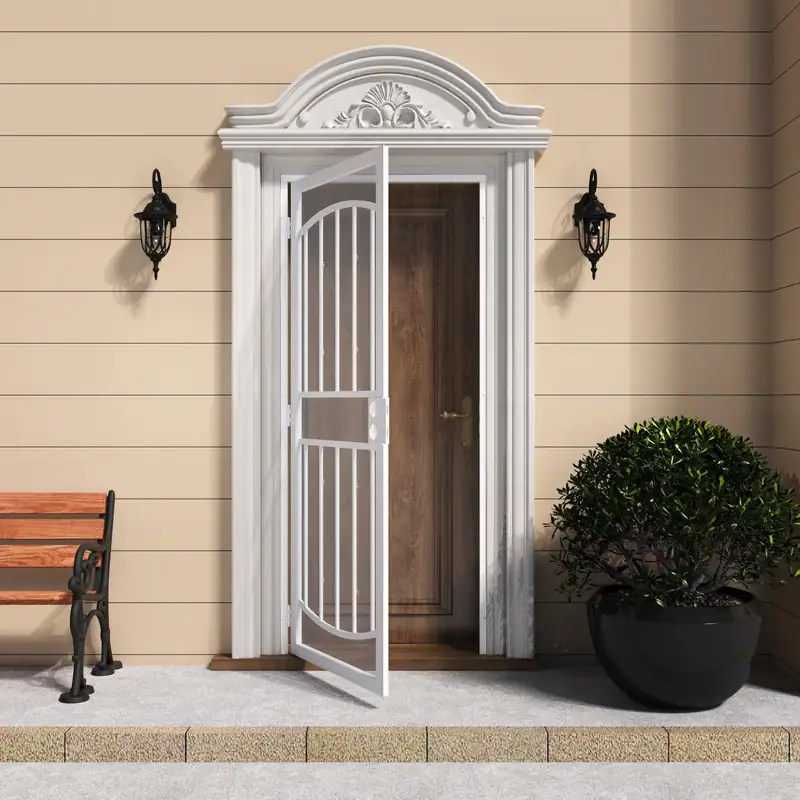 White surface mount steel security door with decorative arch and expanded metal screen, installed on a beige house exterior with black wall-mounted lanterns and a potted shrub.