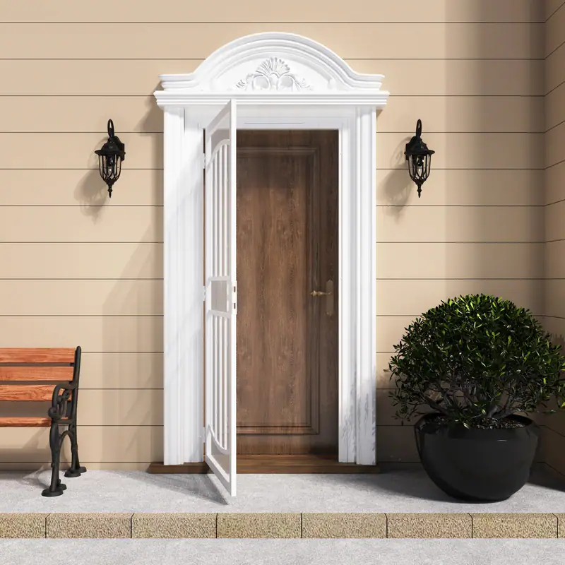 White surface mount steel security door with decorative arch and expanded metal screen, installed on a beige exterior wall with black lanterns and a potted plant.