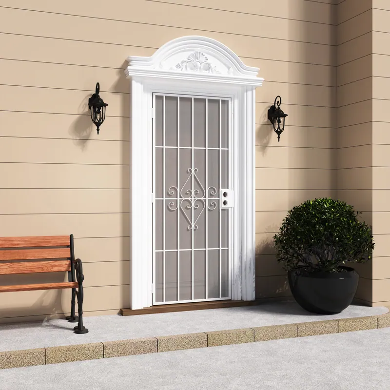 Elegant white security screen door with scrollwork design and expanded metal mesh, flanked by wall-mounted lanterns, with a potted shrub nearby.