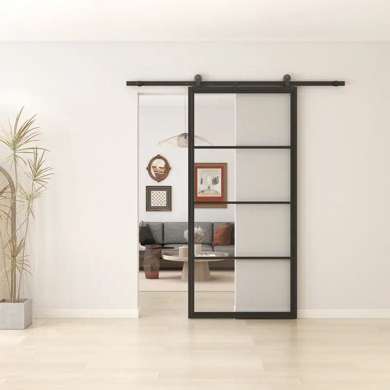 Modern black steel-frame sliding barn door with glass panels in a contemporary home interior.