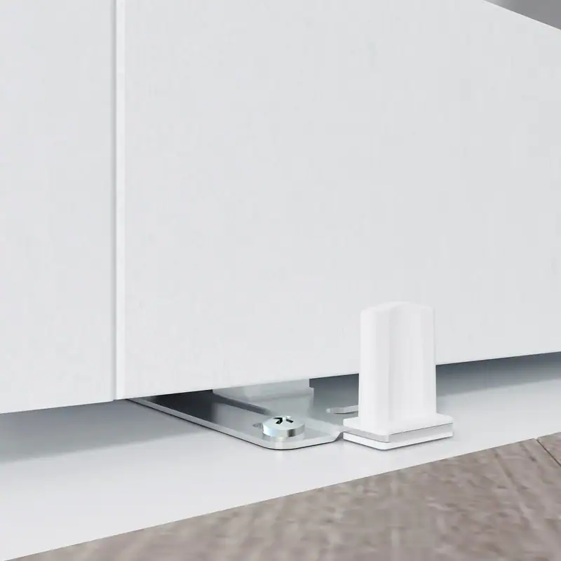Close-up of white frosted glass closet door hardware with metal track and support bracket.