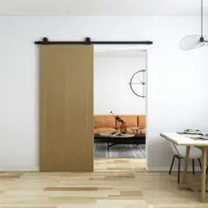 Sliding barn door with wood-look finish and herringbone carving, installed on a black metal track in a modern interior.