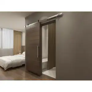 Modern sliding barn door hardware kit with soft close feature, installed on a wooden door in a contemporary bedroom setting, showcasing sleek design and functionality.